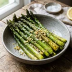 Crispy air fryer asparagus served on a plate with seasonings